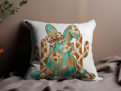 Bunny with cow print and turquoise accents, surrounded by cacti.
