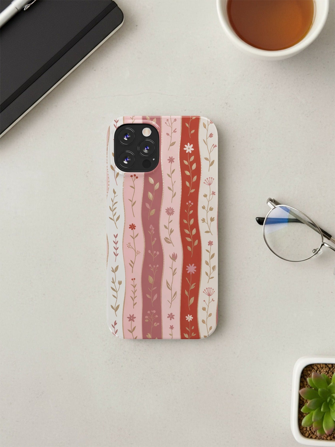 iPhone case with pink and red vertical stripes and floral pattern.