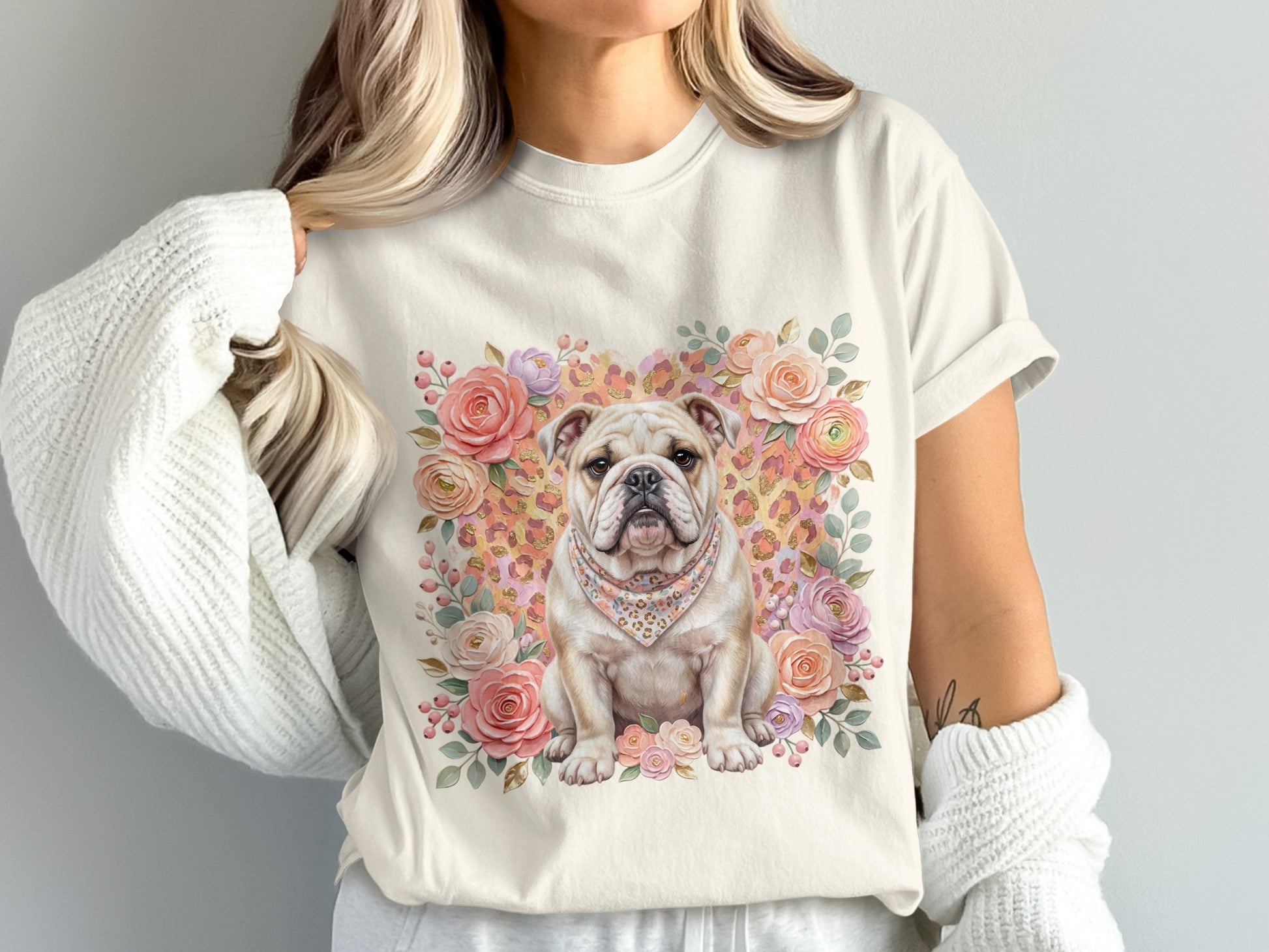Bulldog wearing bandana, surrounded by flowers, on a light cream t-shirt.