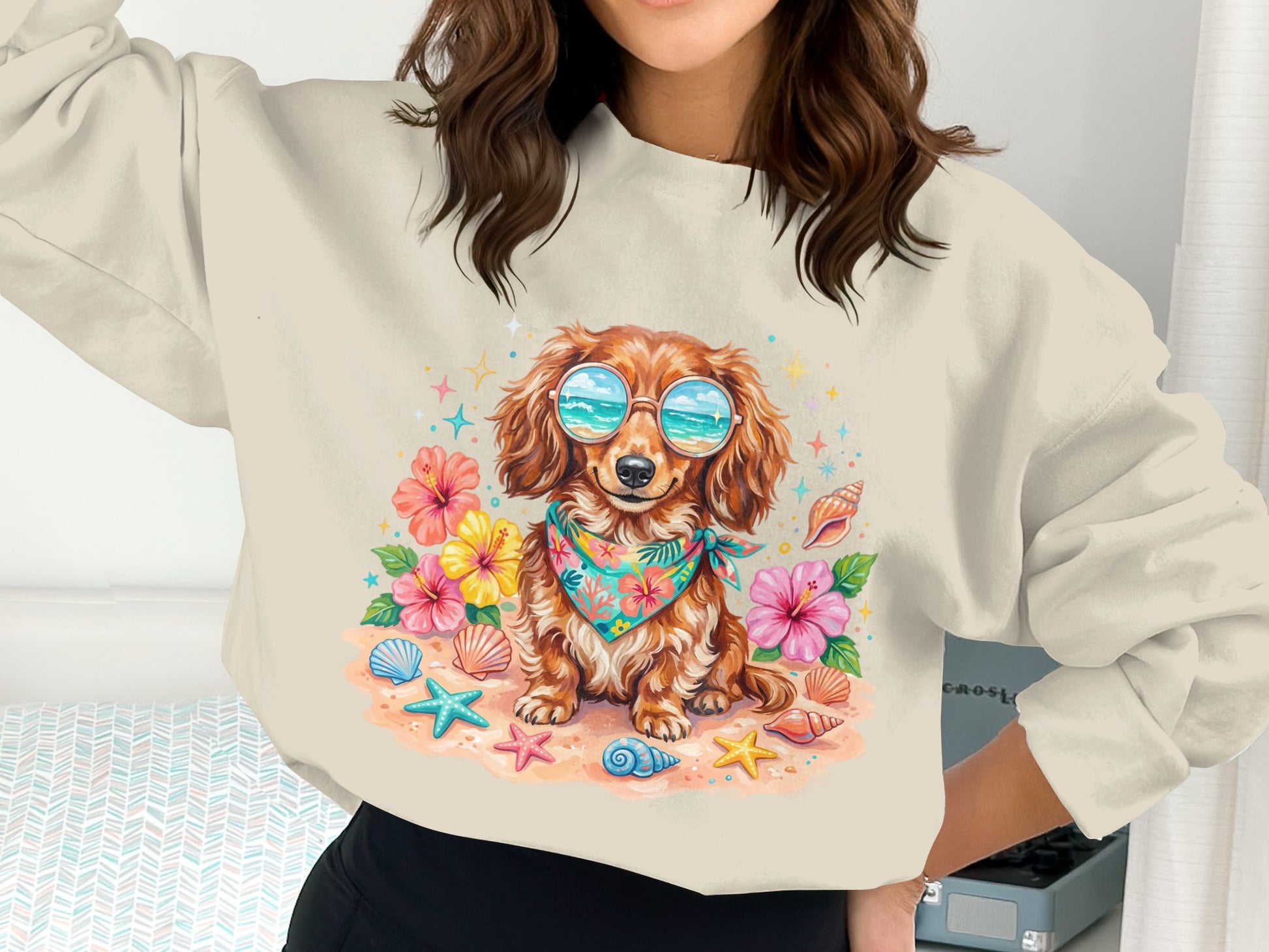 Dachshund wearing sunglasses and bandana on beach with shells and flowers.