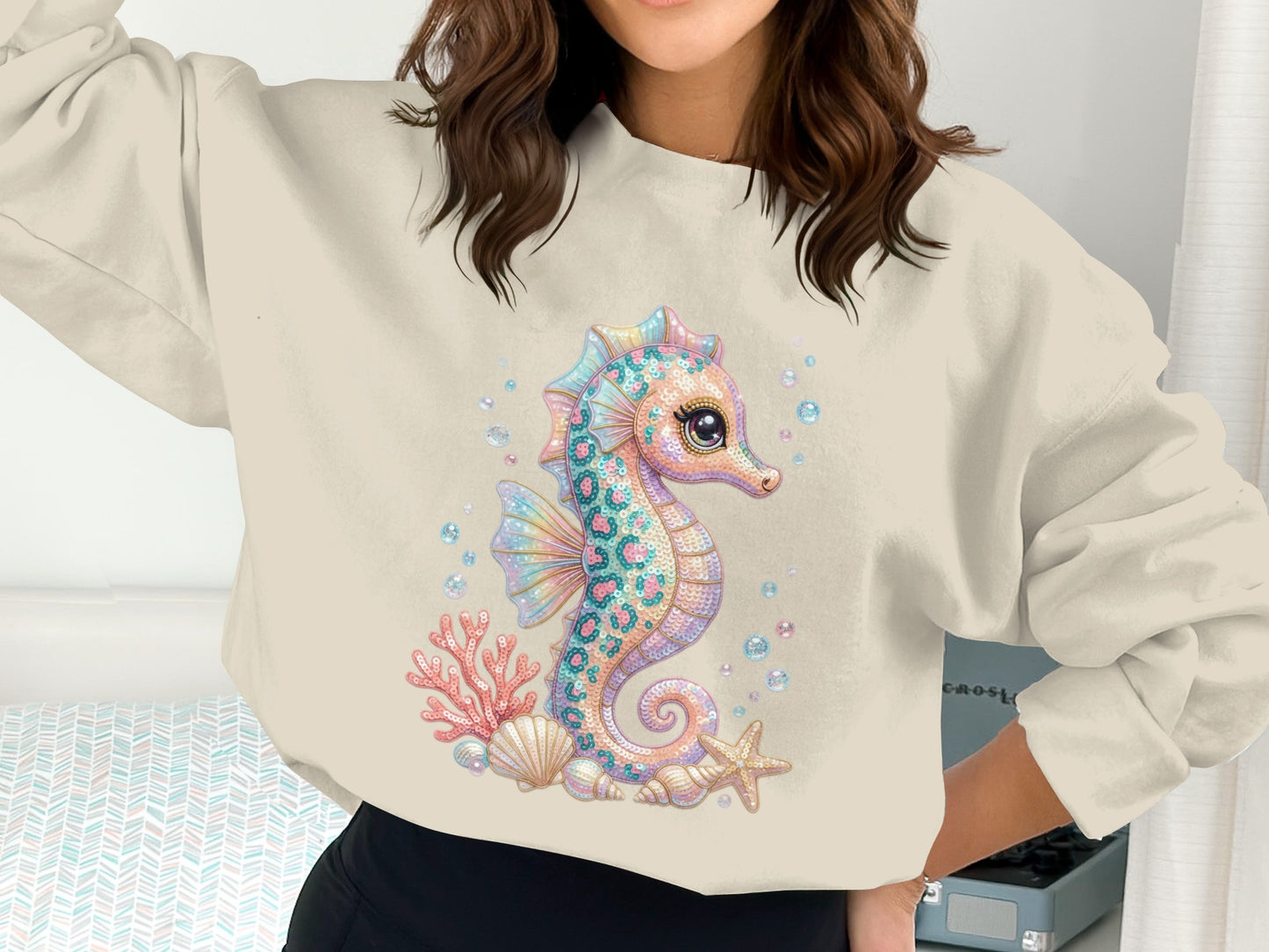 Crewneck sweatshirt with a whimsical seahorse graphic and coral details.