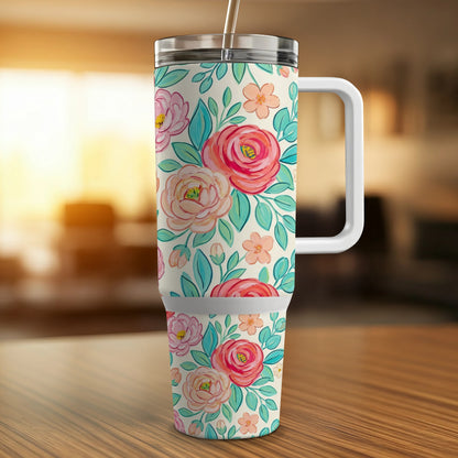 Floral print tumbler with lid and straw on a wooden table.