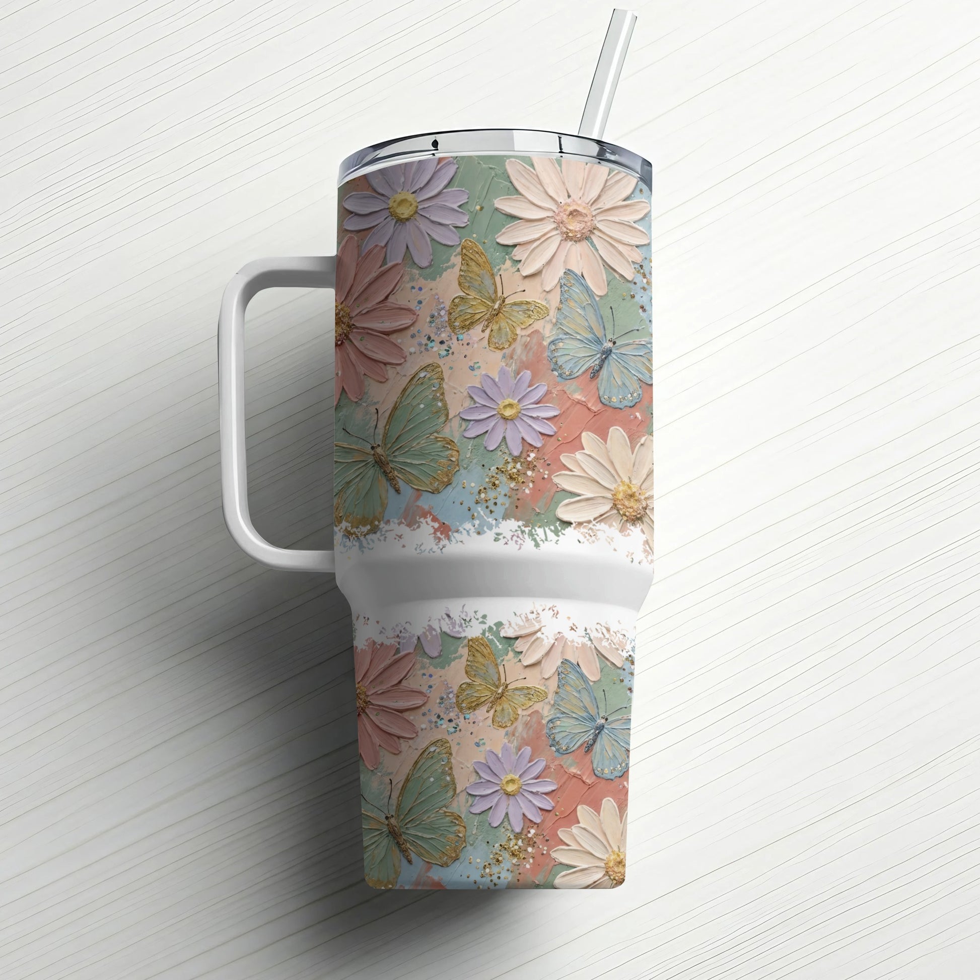 Pastel floral and butterfly design on a white insulated tumbler with straw.