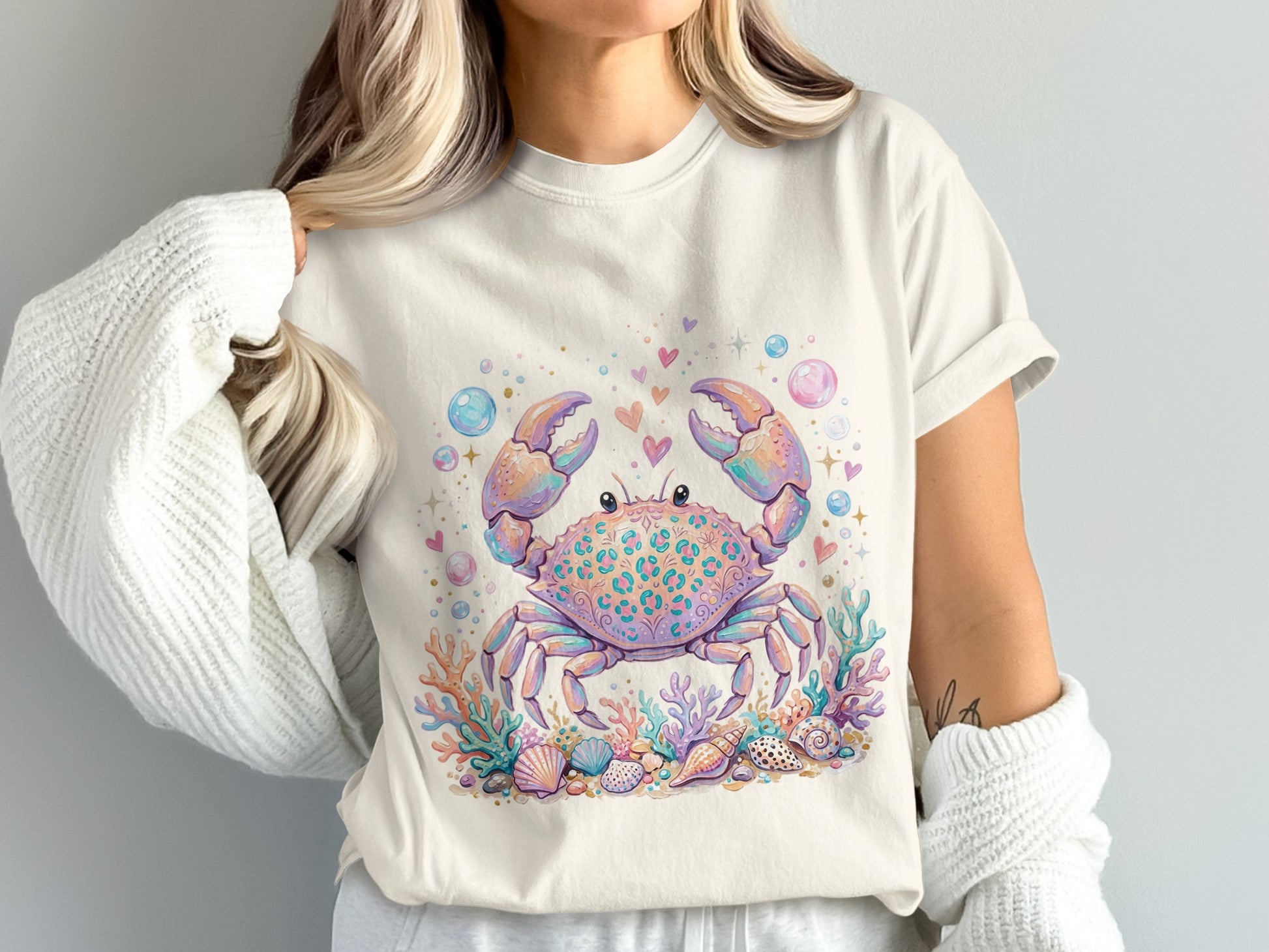 T-shirt with pastel crab graphic, shells, and coral.