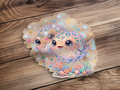 Two cute pufferfish with colorful spots and coral on a wooden background.