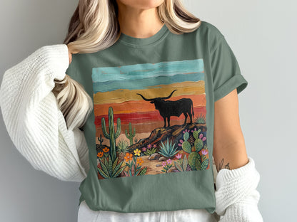 T-shirt graphic with black bull silhouette on a rocky desert landscape.