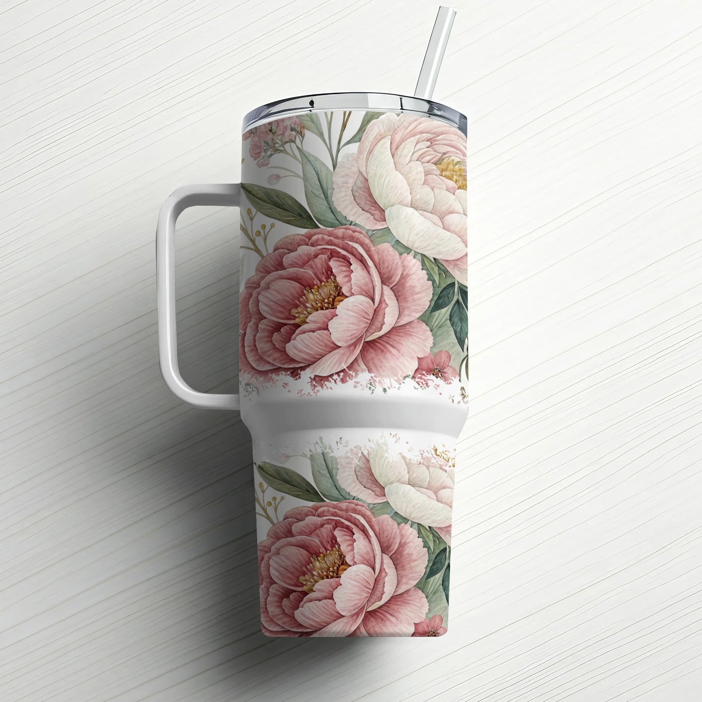 White tumbler with pink and cream peony floral design and straw.