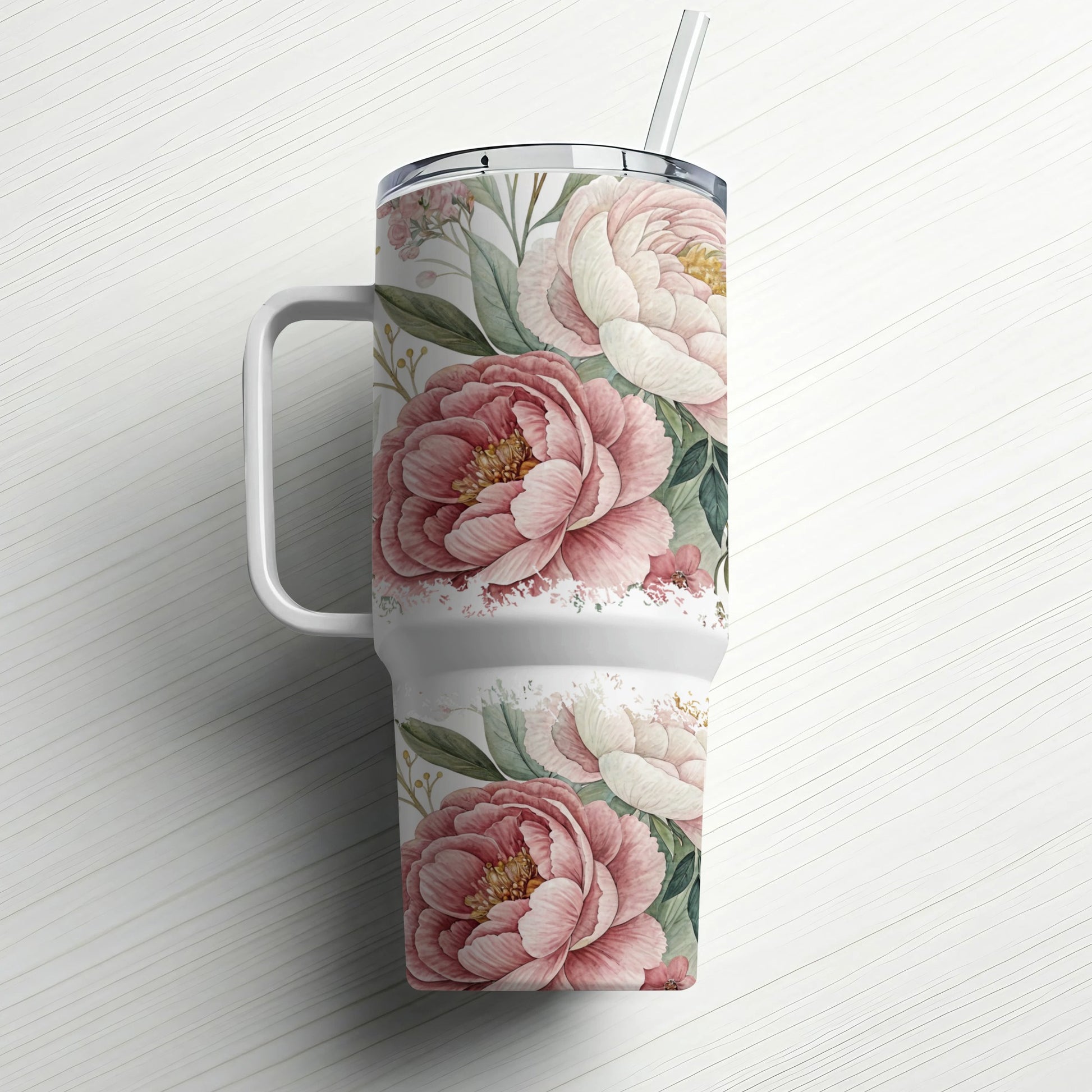 White tumbler with pink and cream peony floral design and straw.