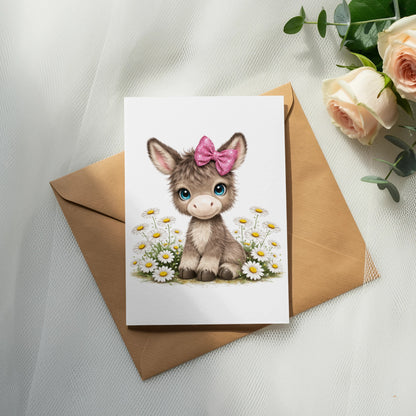 Cute cartoon donkey with pink bow and daisies on a greeting card.