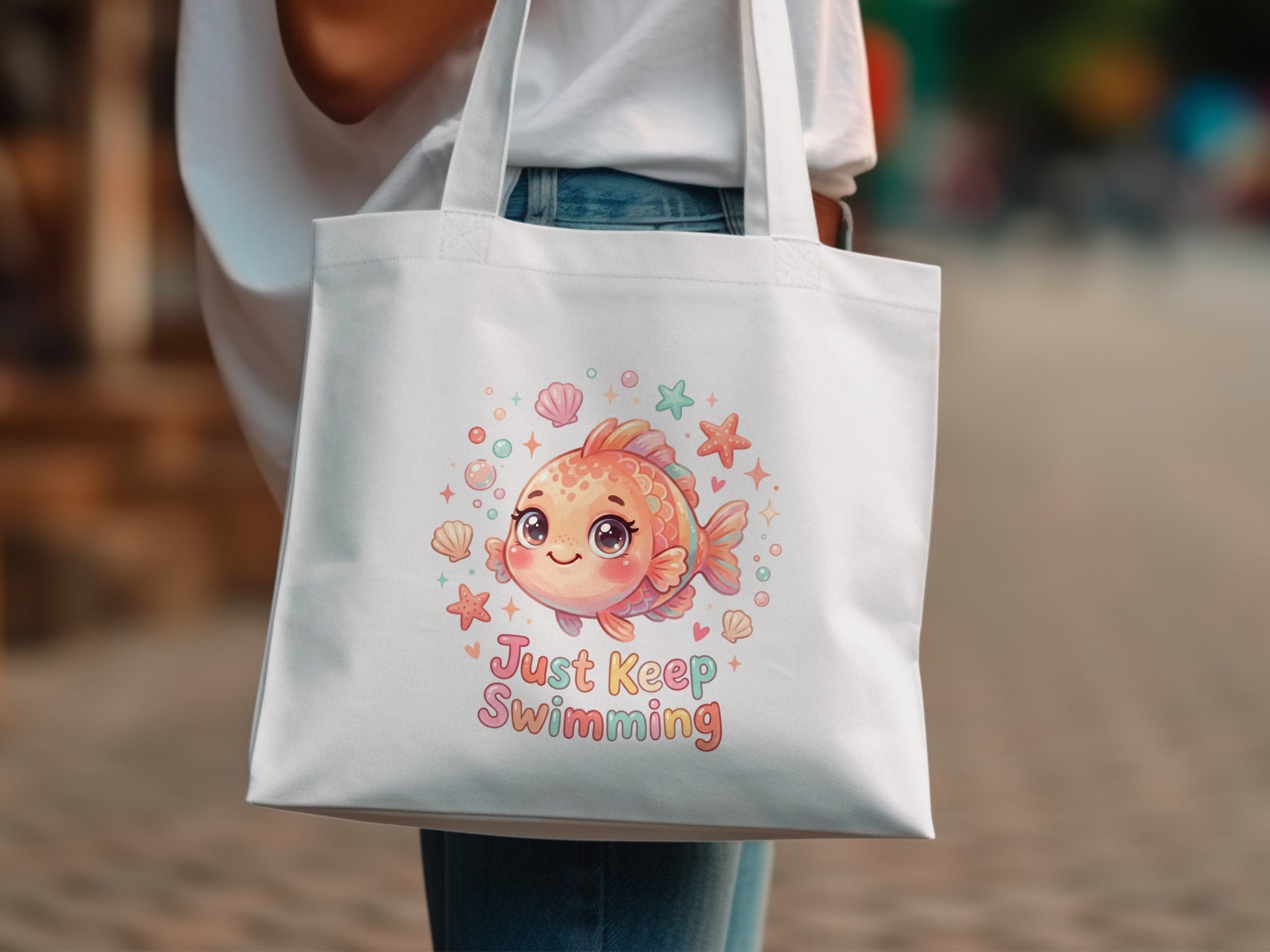 White tote bag with cartoon goldfish and "Just Keep Swimming" text.