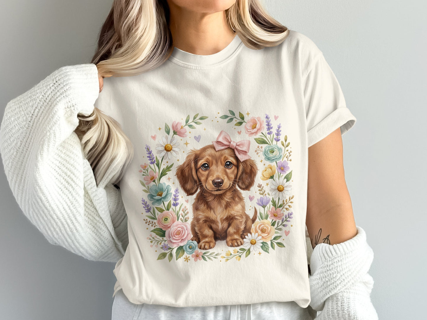 Cream t-shirt with a dachshund puppy in a floral wreath and pink bow.