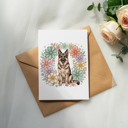 German Shepherd dog sitting inside a pastel floral wreath on a card.