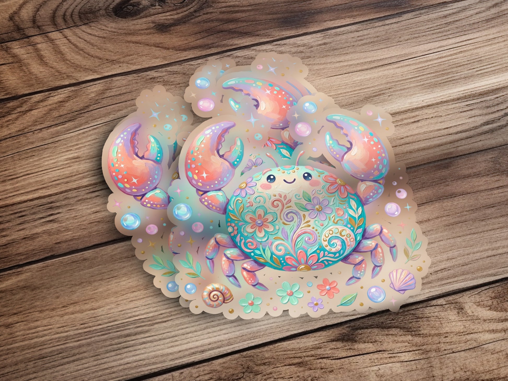 Cute crab sticker with floral and paisley patterns on a wooden background.