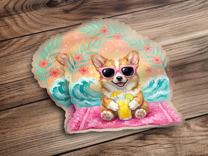 Corgi dog wearing sunglasses and holding a drink on a beach towel.
