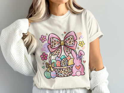 Easter basket with decorated eggs, a bunny, and a bow on a t-shirt.