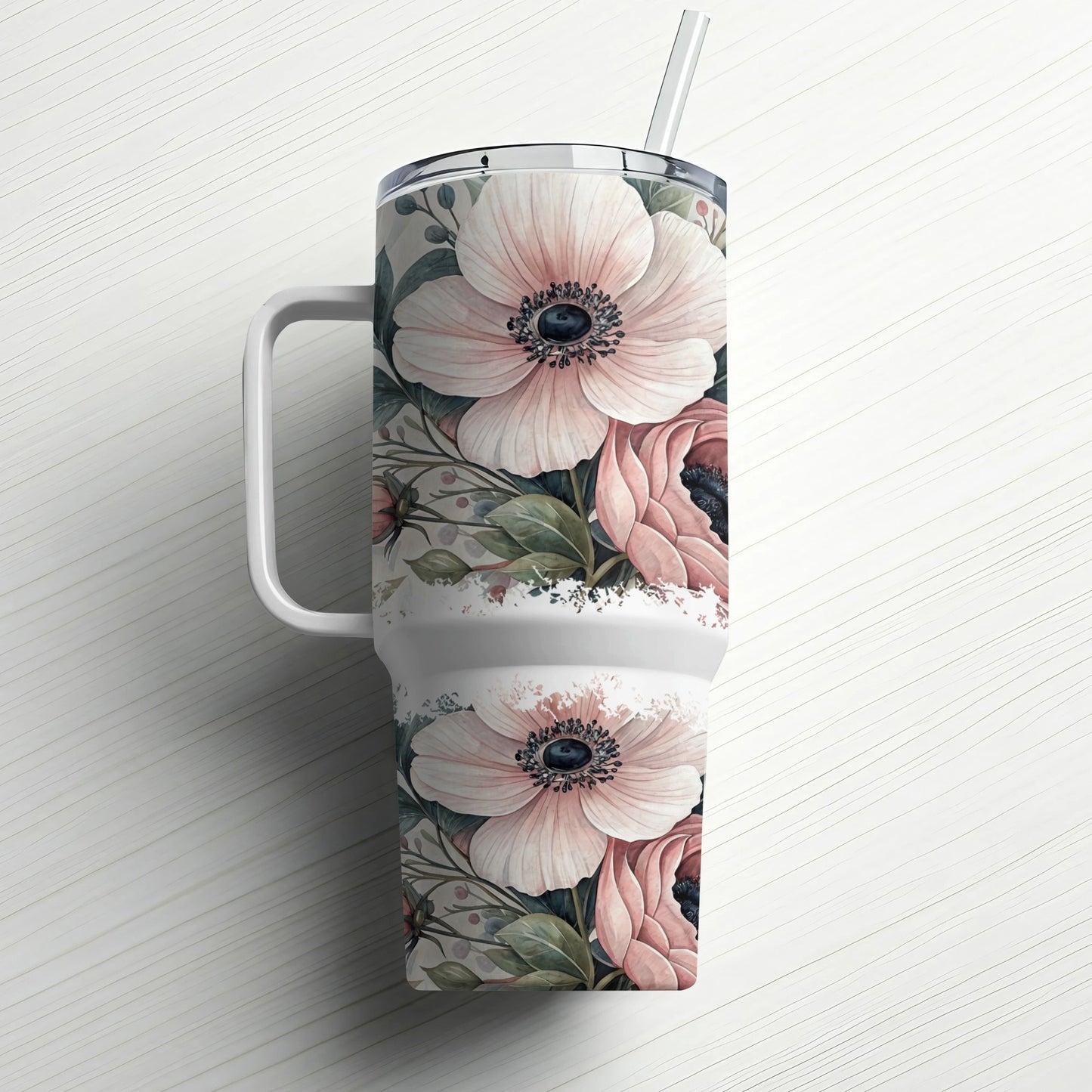 White tumbler with pink floral pattern and straw.