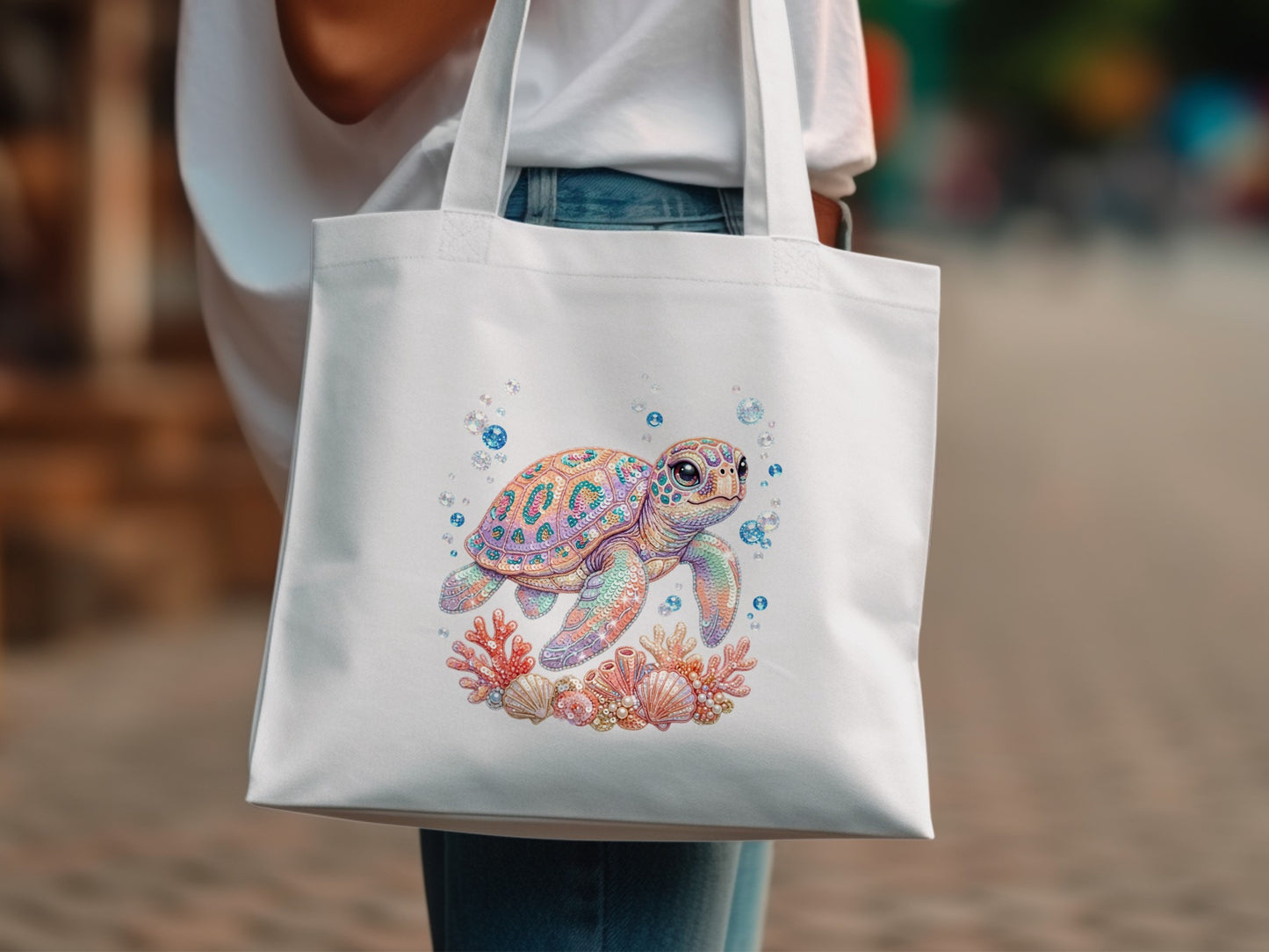 White tote bag with colorful cartoon sea turtle and coral reef design.