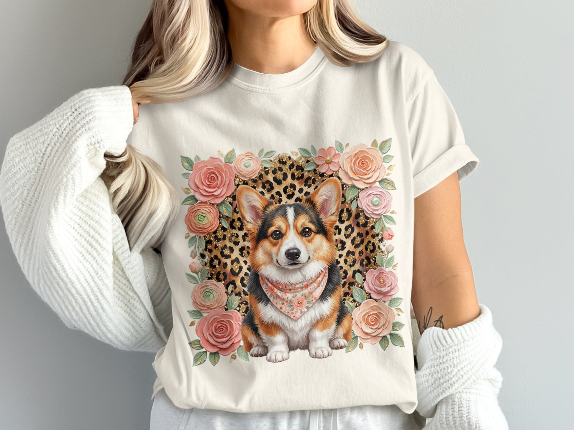 Cream t-shirt with a corgi wearing a bandana surrounded by flowers and leopard print.