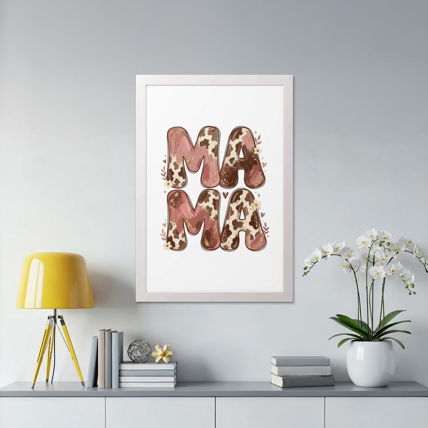 Framed artwork with "MAMA" in cow print and floral accents.