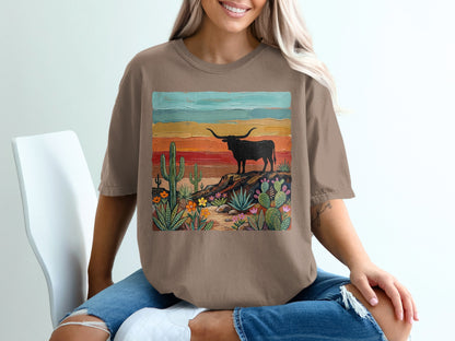 Brown t-shirt featuring a desert landscape with a longhorn cattle silhouette.