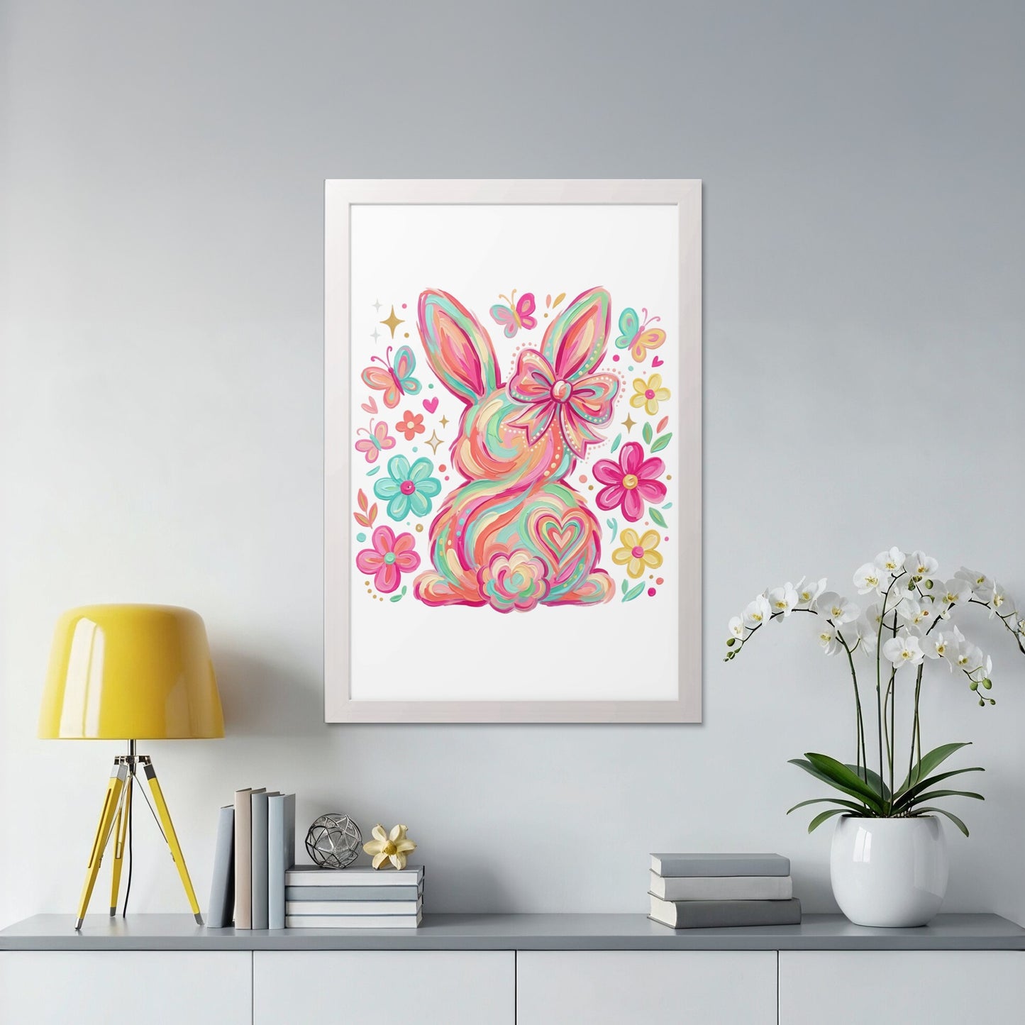 Colorful bunny illustration with butterflies and flowers, framed on a wall.