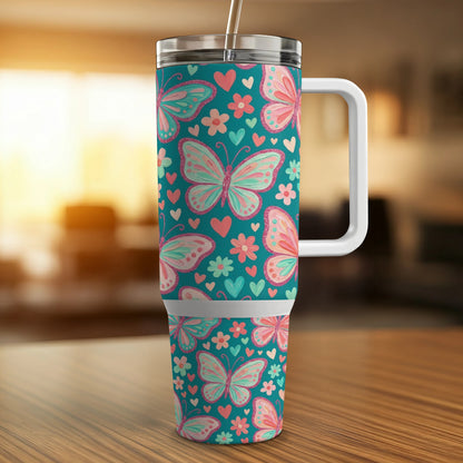 Teal tumbler with butterflies and hearts pattern.