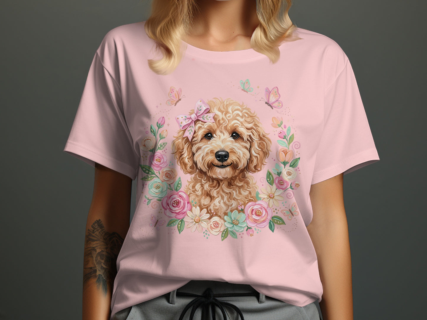 Pink t-shirt with a cute doodle dog wearing a bow in a floral wreath.