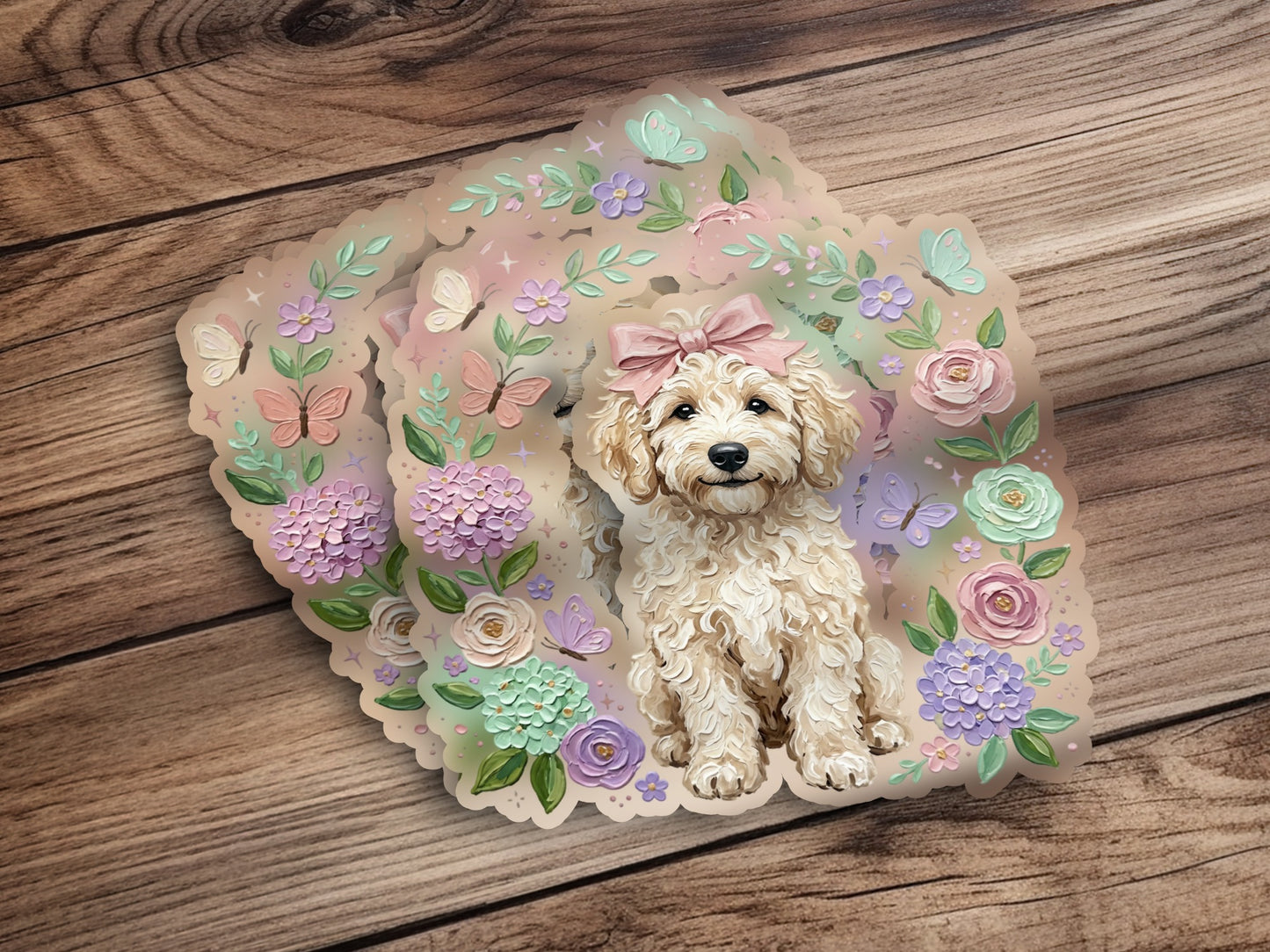 Cream poodle puppy with pink bow and floral accents on wooden background.