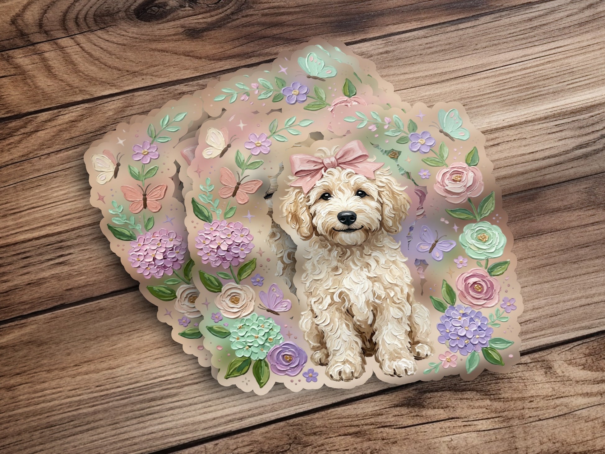 Cream poodle puppy with pink bow and floral accents on wooden background.