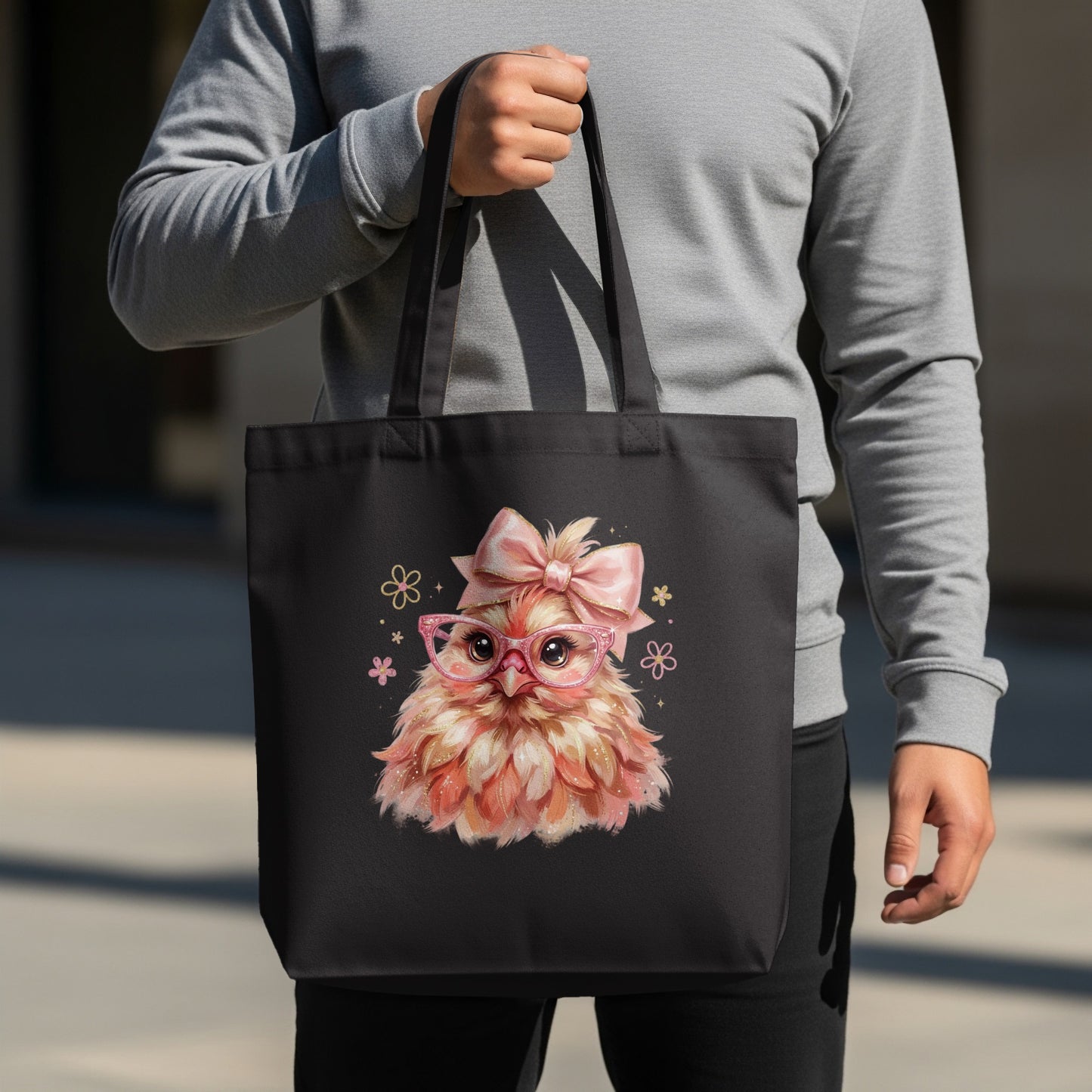 Black tote bag with pink glasses-wearing chick illustration and bow.