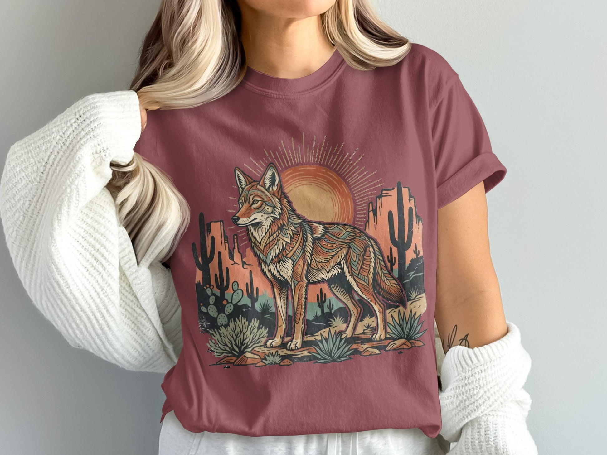 T-shirt with desert coyote and cactus graphic with sun setting.