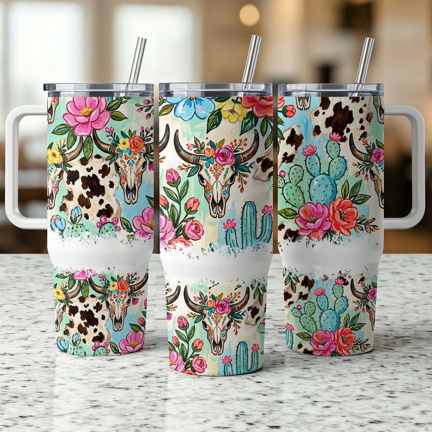 Three tumblers with floral skulls, cacti, and cow print designs.