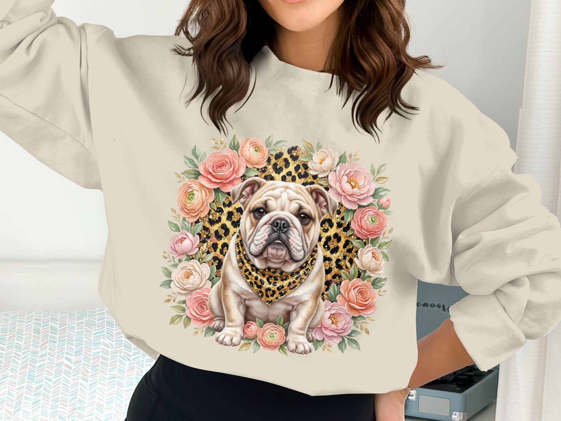 Bulldog wearing bandana surrounded by floral wreath on sweatshirt.