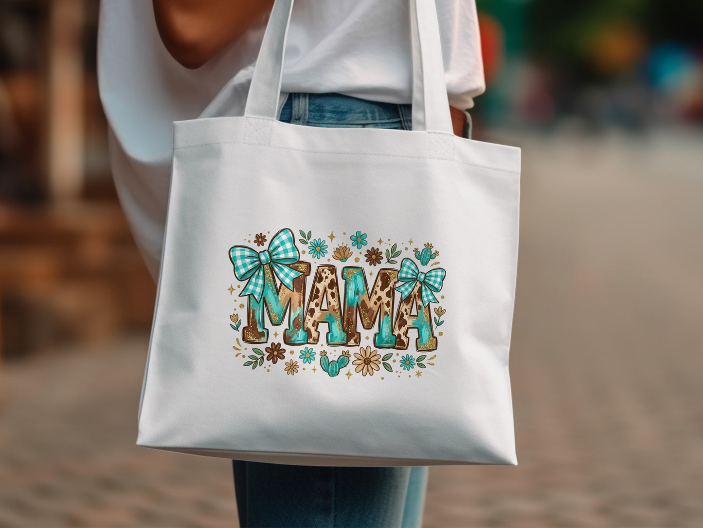 White tote bag with "MAMA" in leopard print, turquoise bows, and floral accents.