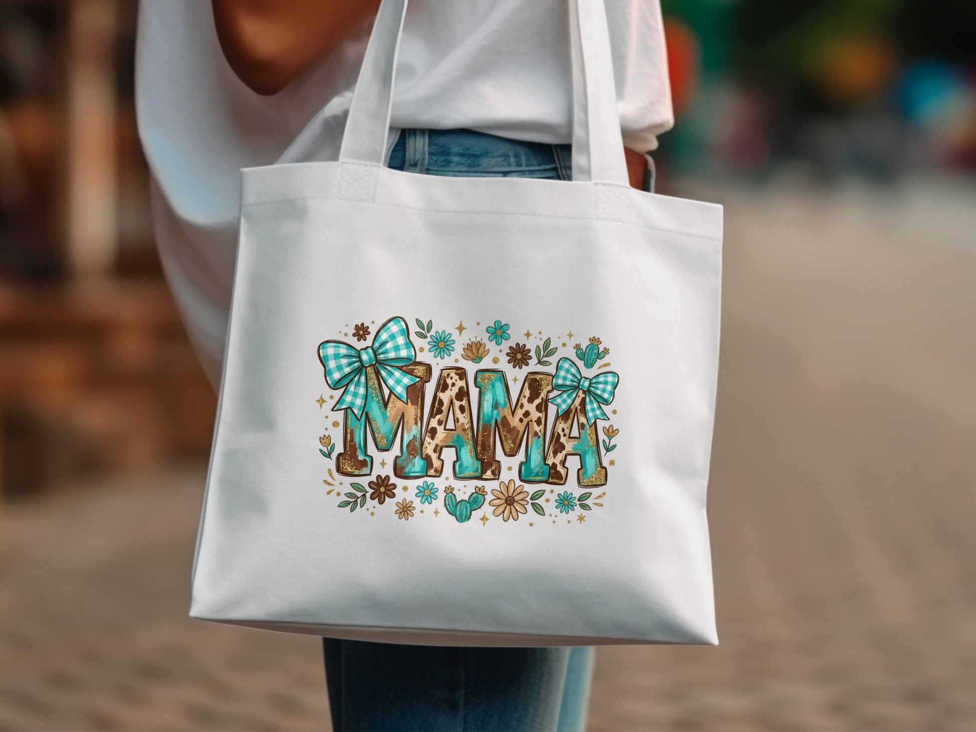 White tote bag with "MAMA" in leopard print, turquoise bows, and floral accents.