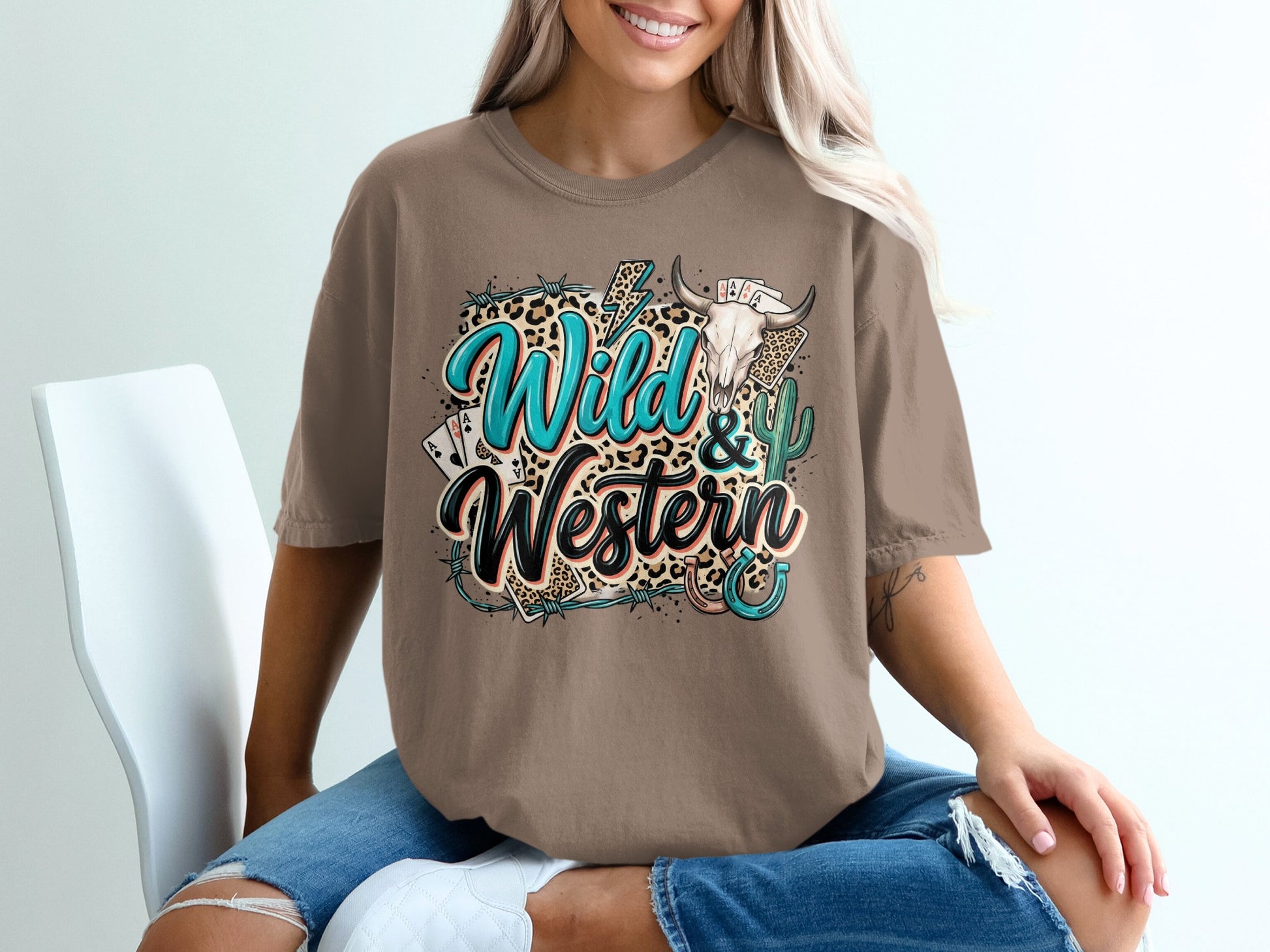Brown t-shirt with "Wild & Western" text, bull skull, cactus, and playing cards graphic.