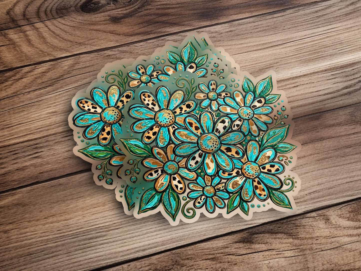 Teal and gold floral stickers with leopard print centers on wood.