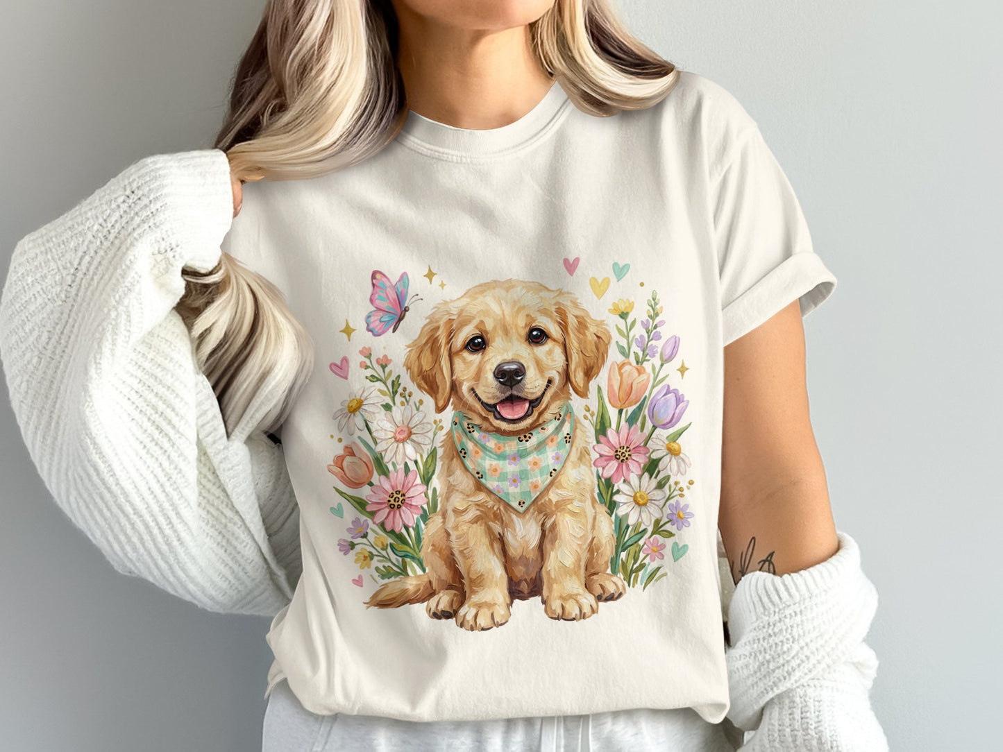Golden retriever puppy wearing a bandana surrounded by flowers and hearts.