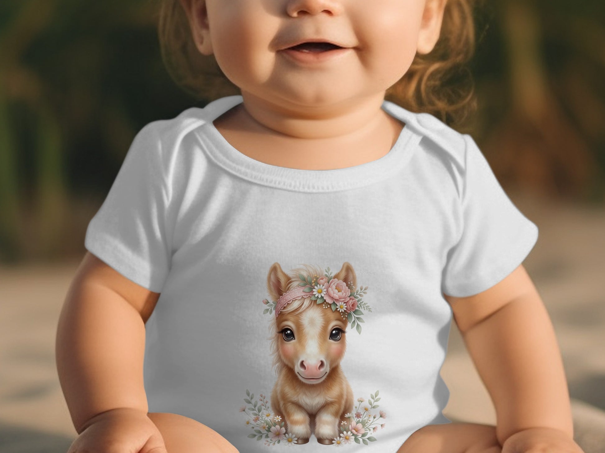 Baby wearing white onesie with floral horse graphic.