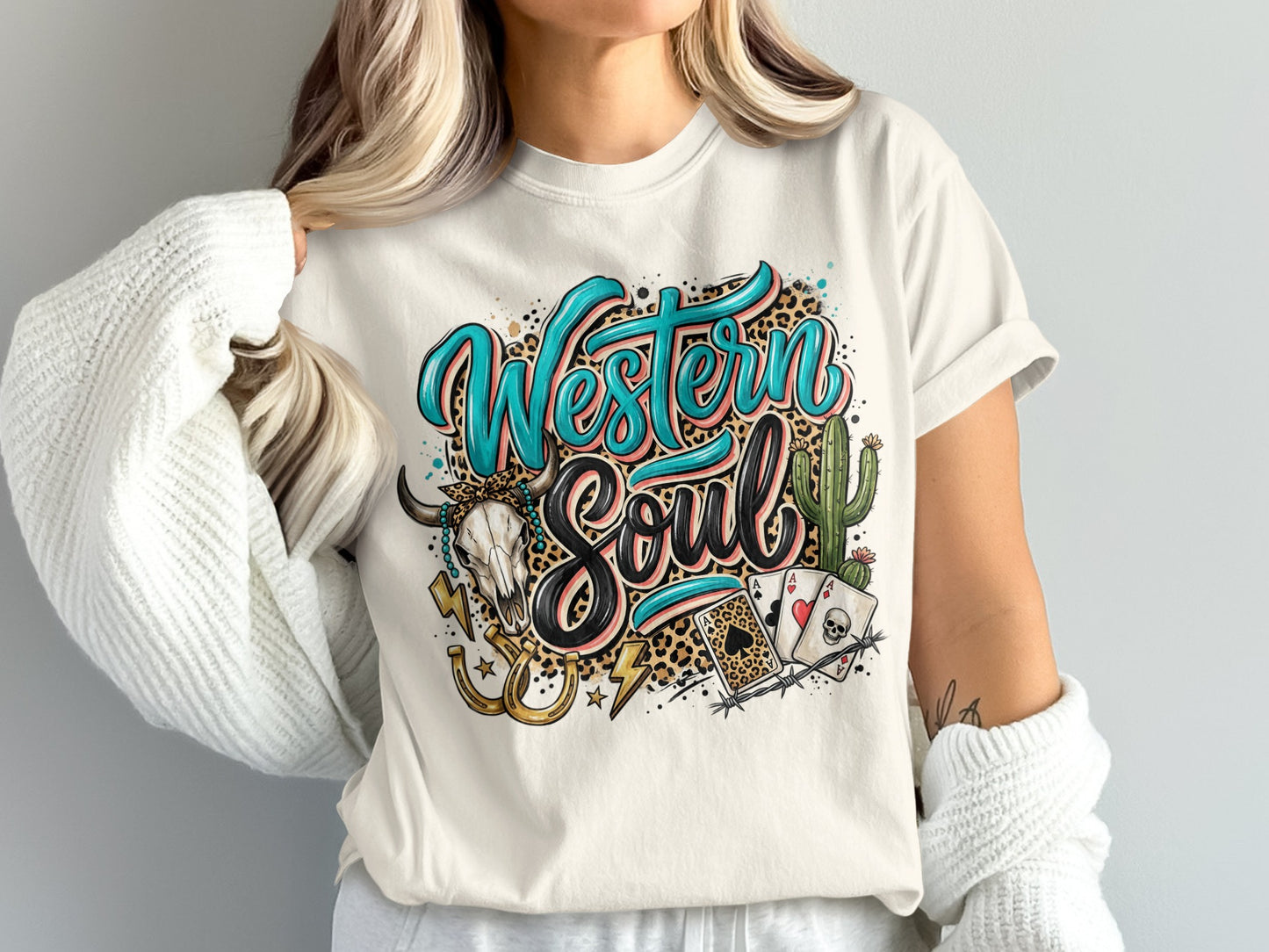Cream t-shirt with "Western Soul" in leopard print, skull, cactus, and playing cards.
