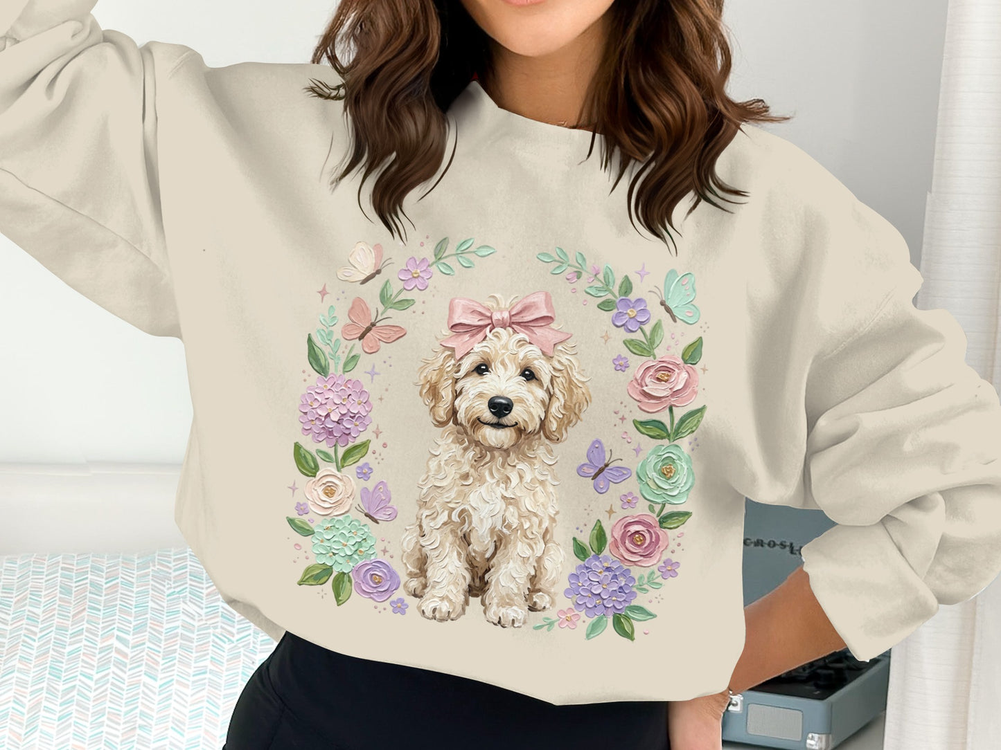 Cream sweatshirt with fluffy dog and floral wreath graphic.