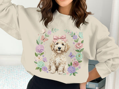 Cream sweatshirt with fluffy dog and floral wreath graphic.