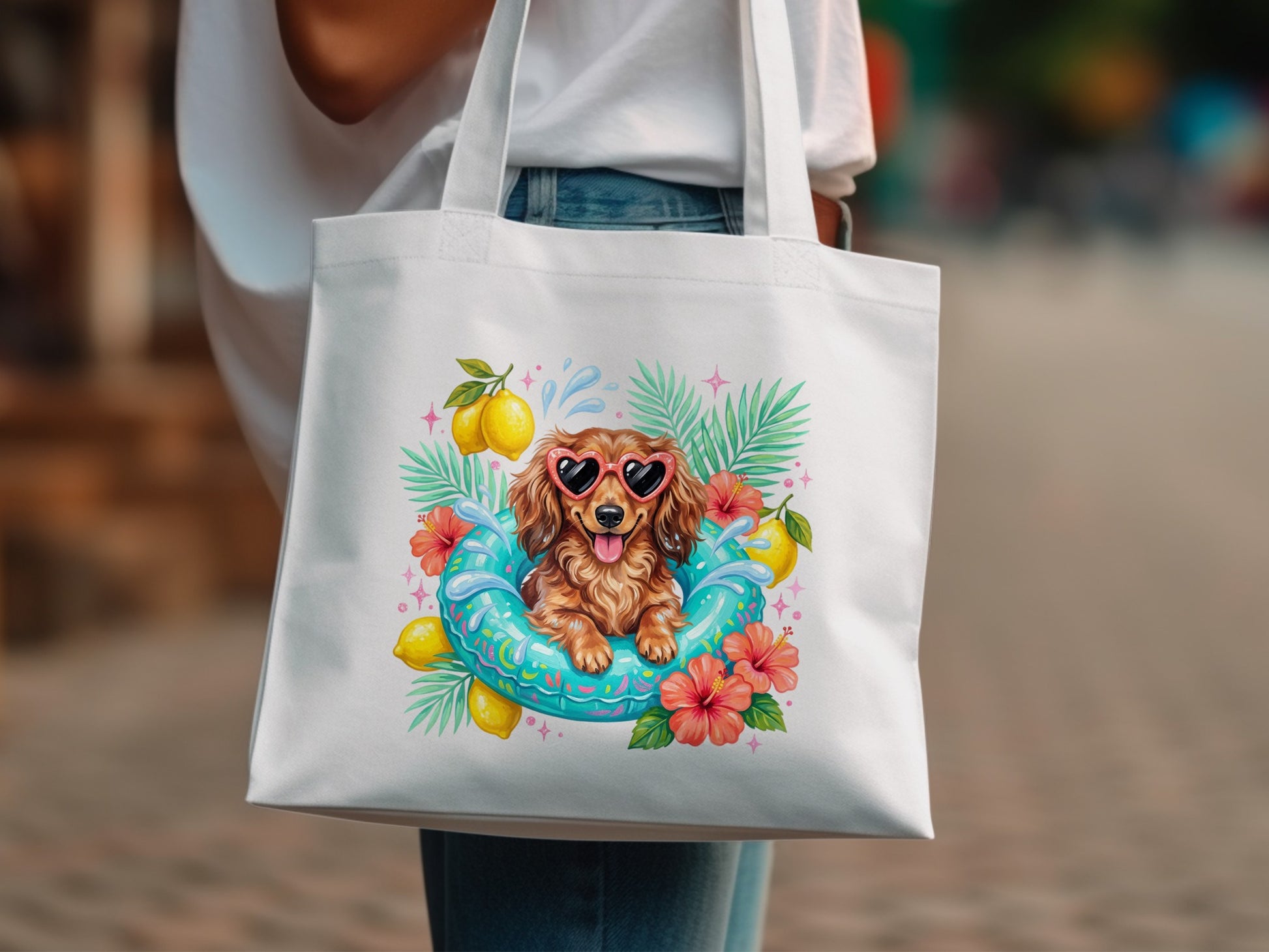 White tote bag with a dachshund wearing sunglasses in a pool float surrounded by lemons and flowers.