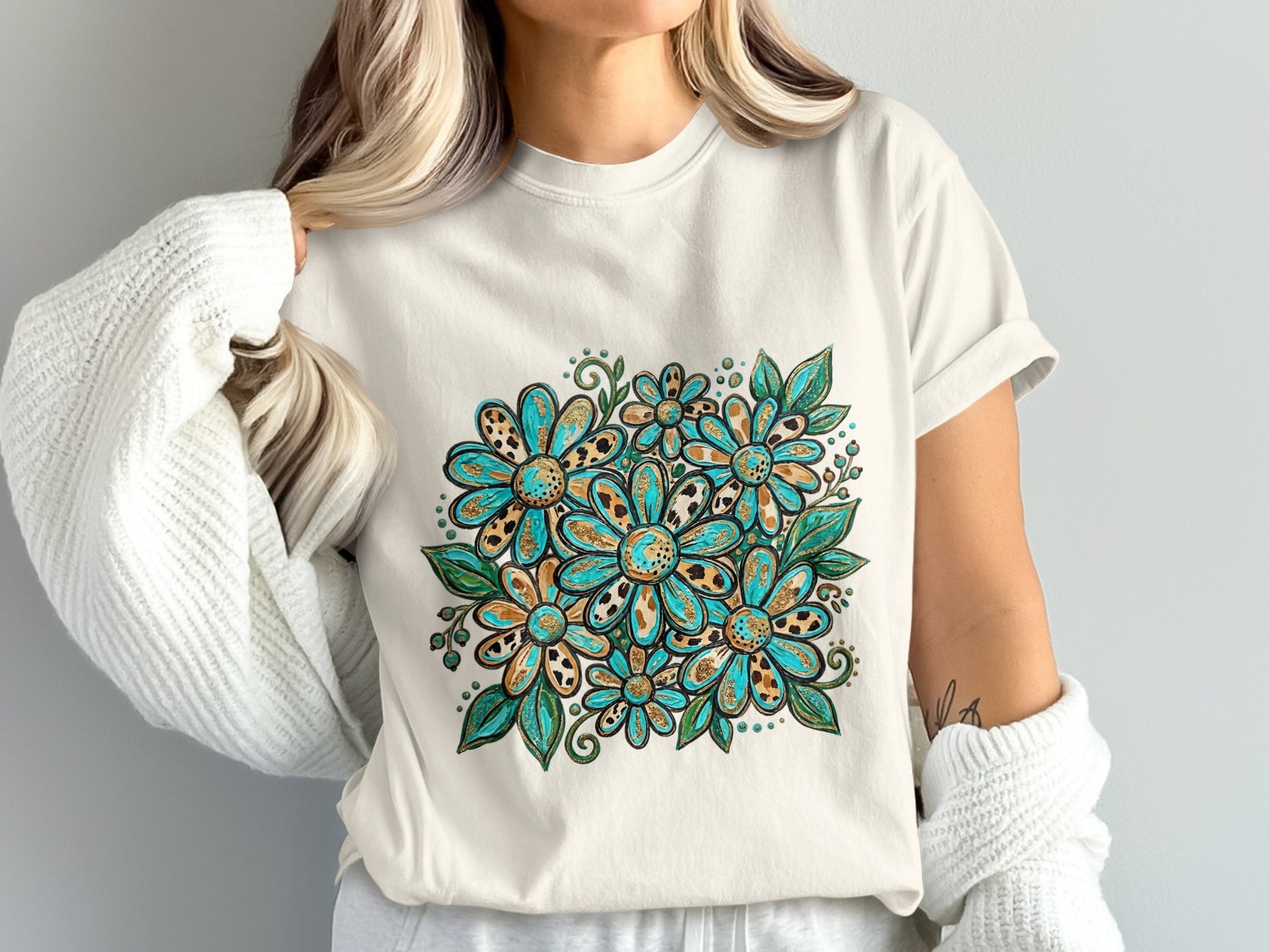 White t-shirt with a colorful floral bouquet design featuring teal, gold, and brown flowers.
