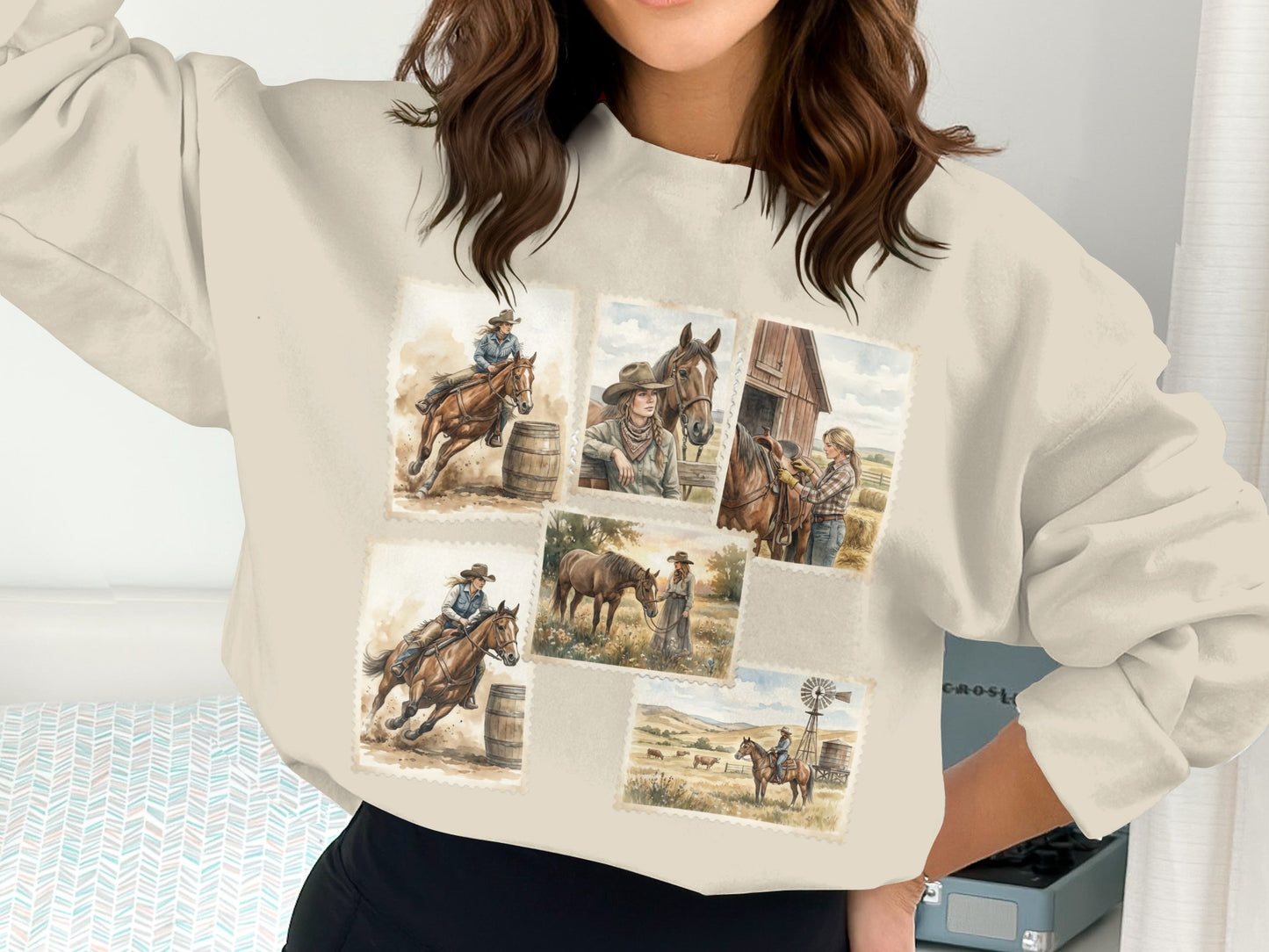 Crewneck sweatshirt with cowgirl and horse illustrations on a muted background.