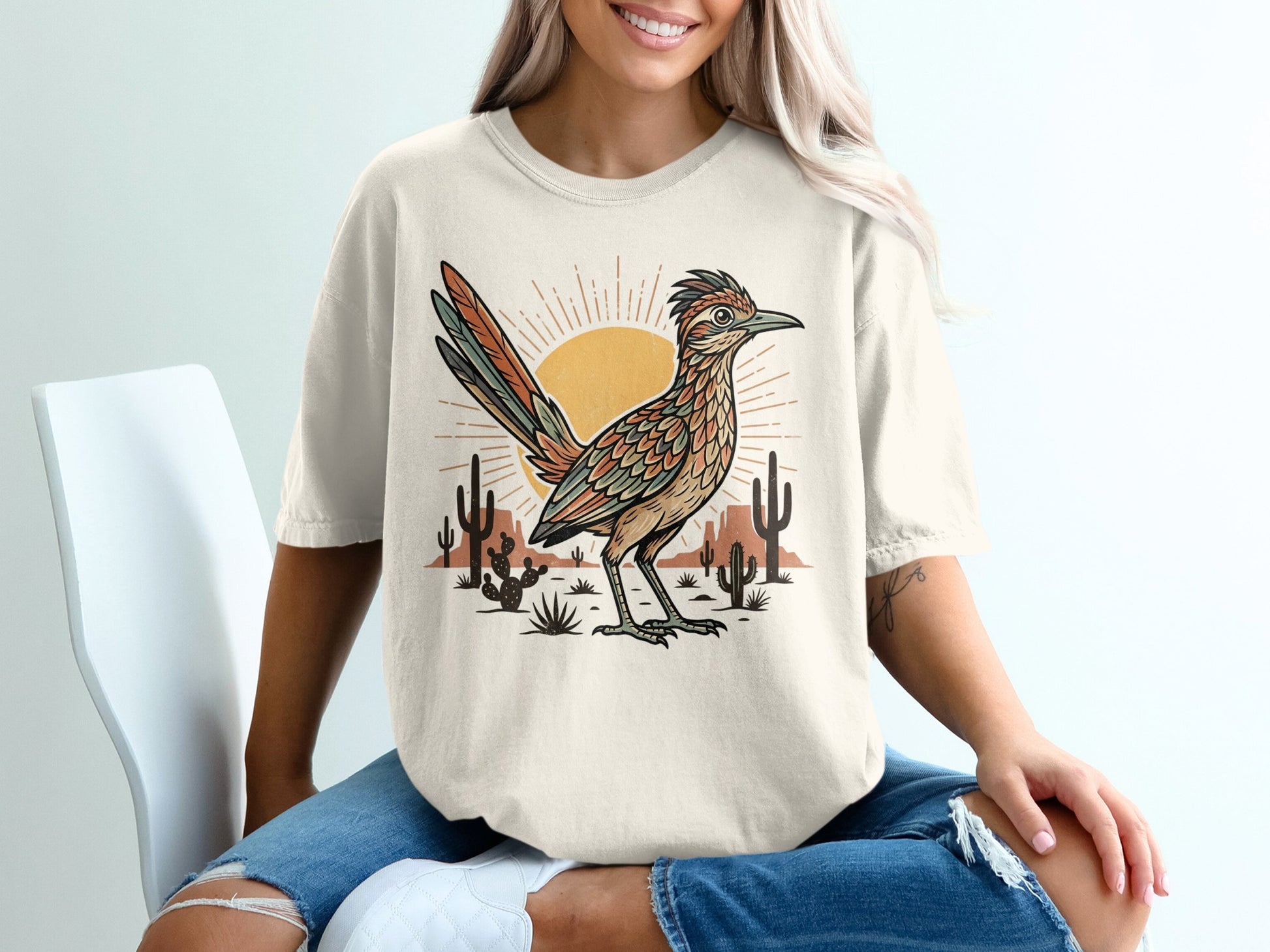 T-shirt with desert landscape and roadrunner graphic.