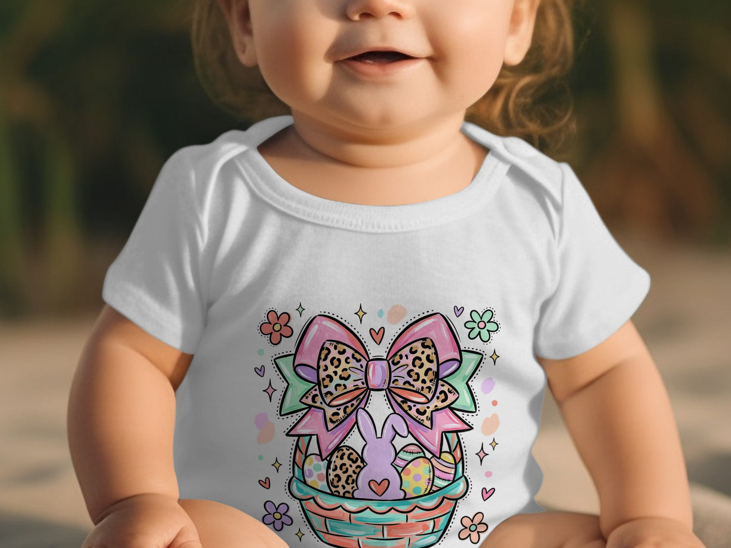 Baby in white onesie with Easter basket and bow graphic.