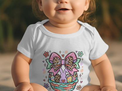Baby in white onesie with Easter basket and bow graphic.