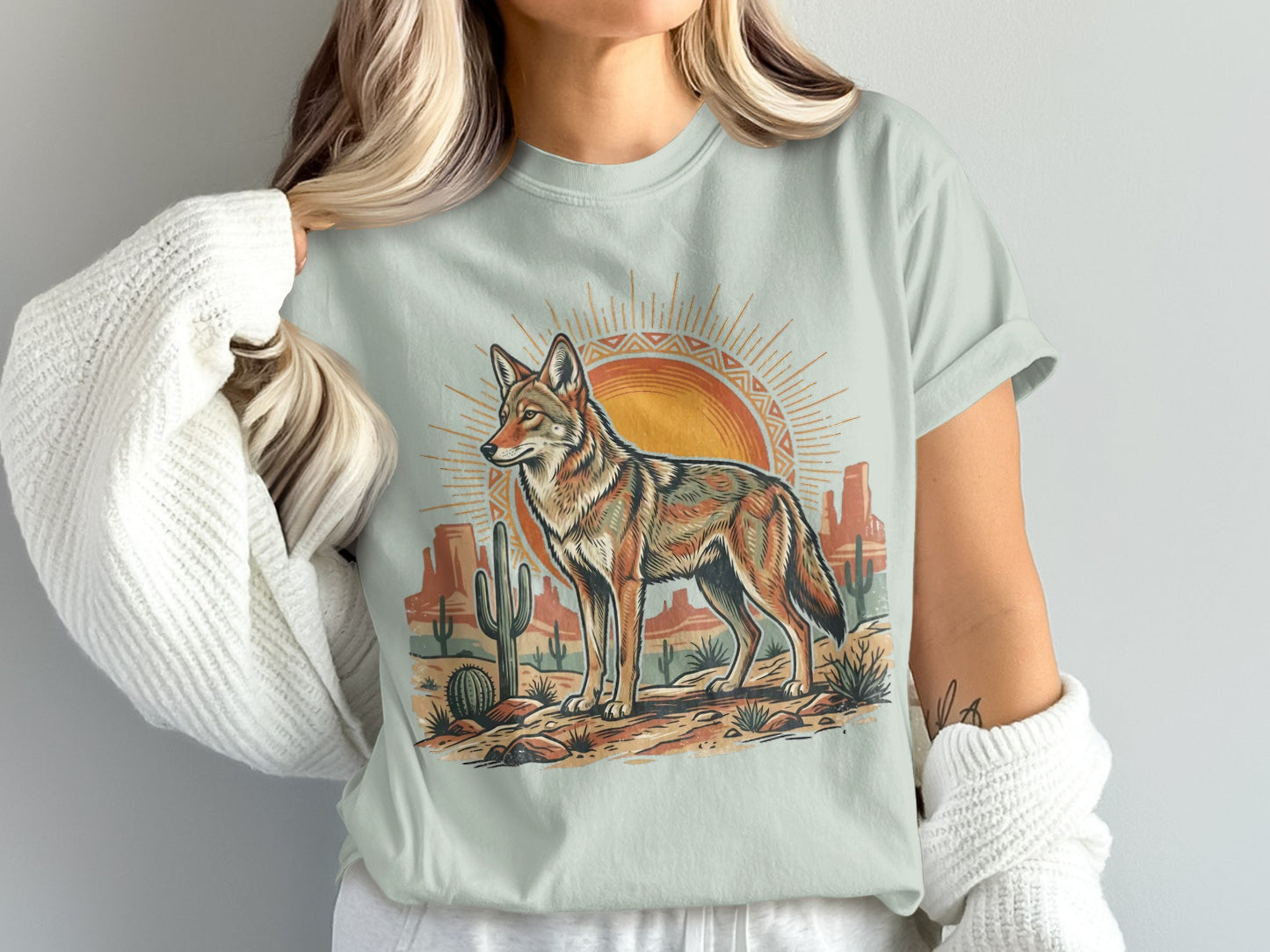 Coyote standing in desert landscape with sun and cacti.