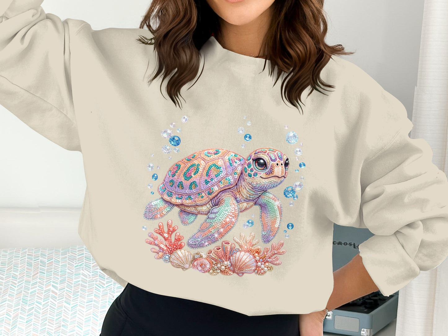 Crewneck sweatshirt with a pastel sea turtle surrounded by coral and bubbles.